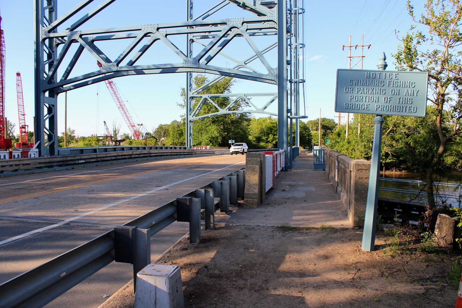 Car passes over the Nortonville Bridge Historic Truss Bridge in Oldmans Township