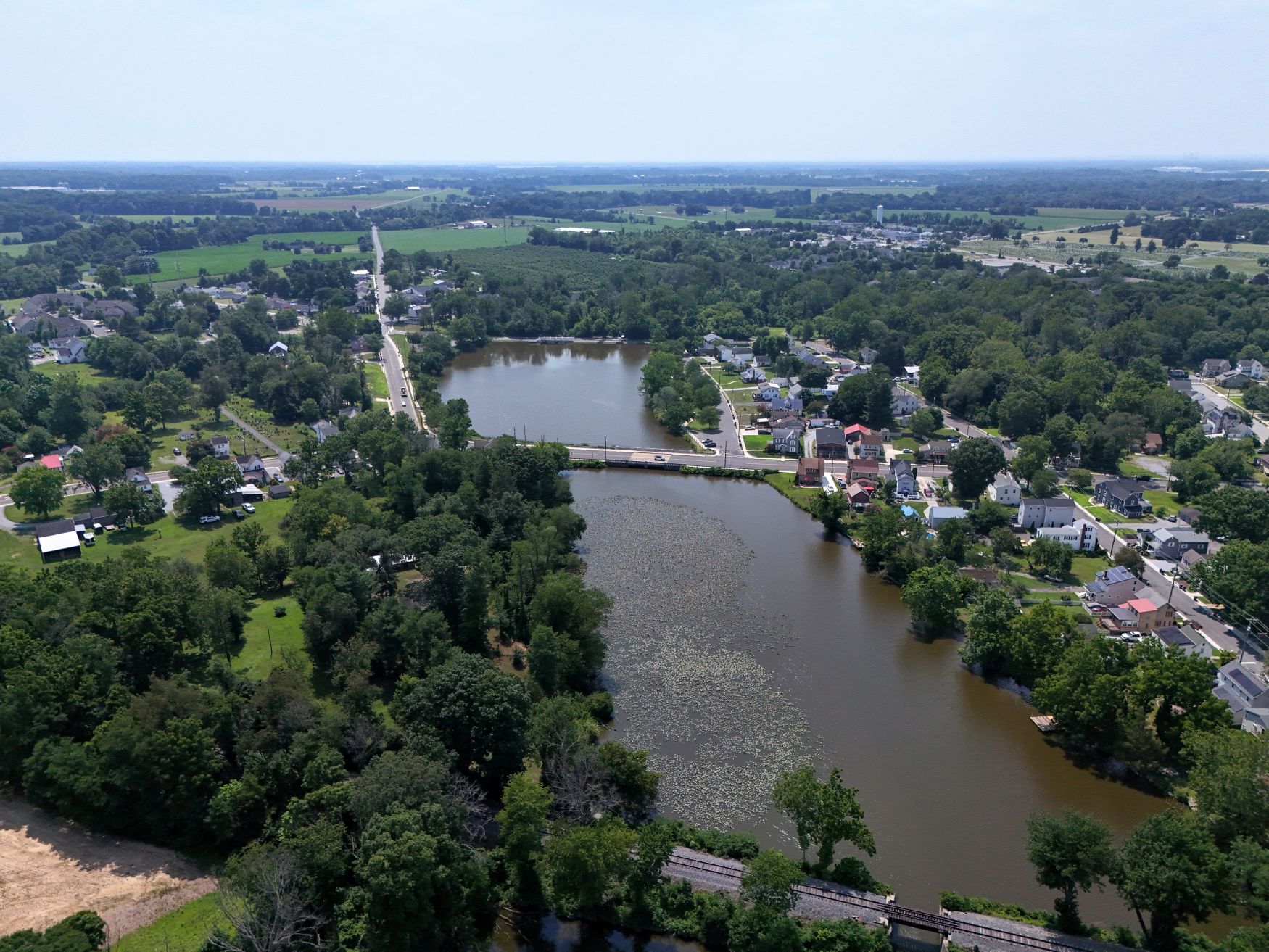 Majority of the lake with both the railroad bride and vehicle bridge in view